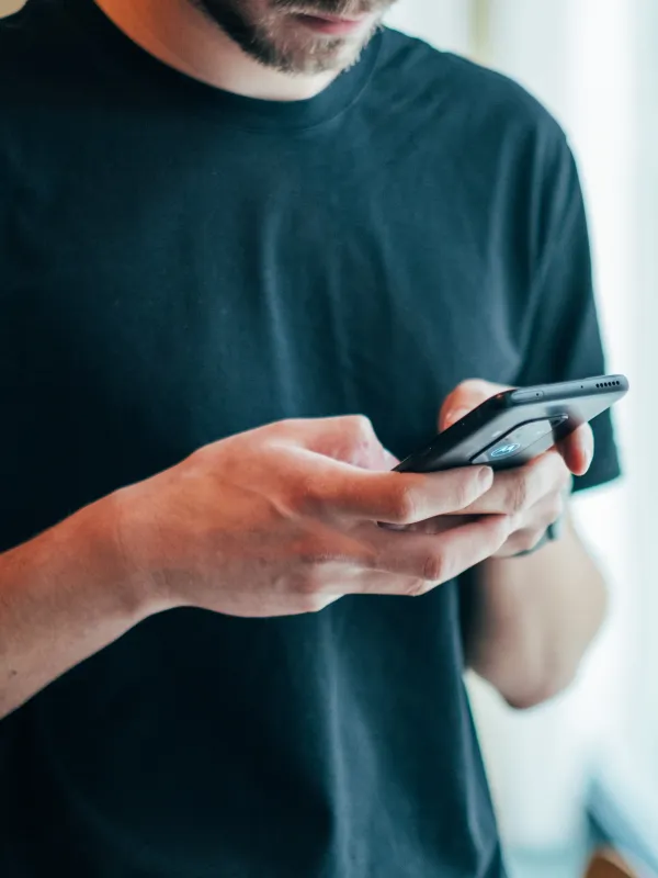 Man using smartphone - Photo by Jonas Leupe on Unsplash
